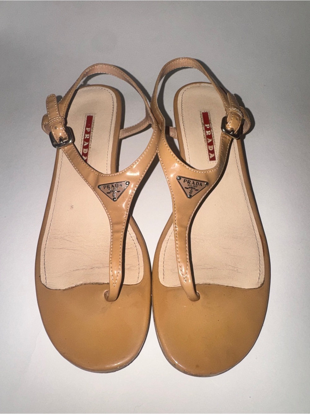 Prada Beige Patent Leather T-Strap Sandals with Logo Plaque
